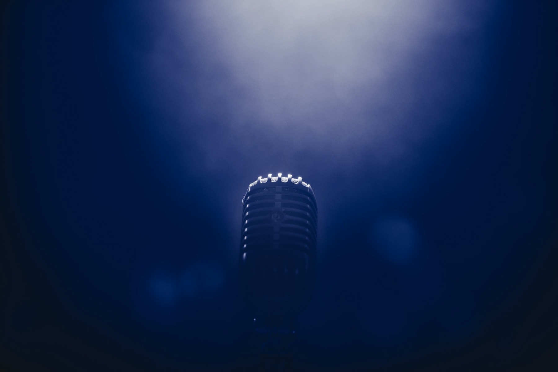 A microphone under a single spotlight before the show